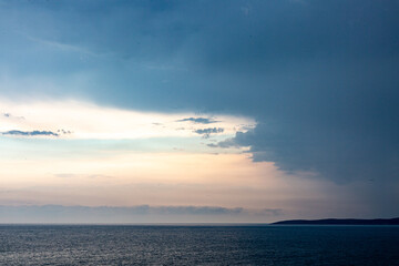 Sunset on the sea shore with dramatic sky