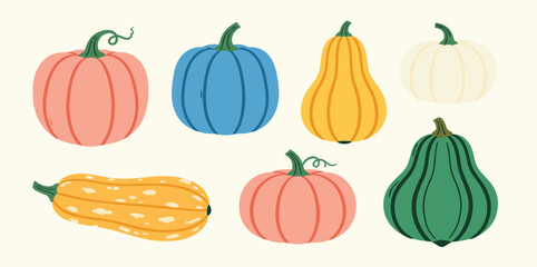 Autumn pumpkins in orange, white, and yellow tones with autumn leaves and twigs, fall harvest