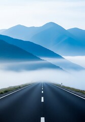 A paved road stretches into a hazy mountain landscape