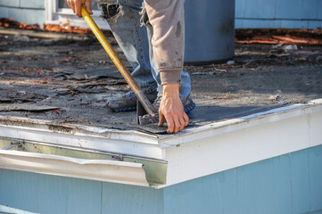 handyman working on repair the damaged roof