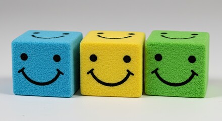 Three colorful smiley face cubes lined up, radiating positivity and happiness in a clean studio setting, perfect for conveying joy and good vibes.
