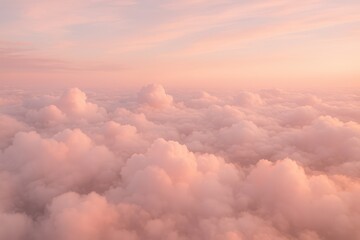 Sky Serenity: A captivating aerial view of a cloudscape bathed in the soft, warm hues of dawn. The ethereal beauty of the sky and clouds invites contemplation. 