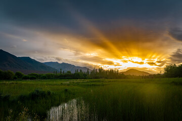Golden Sun Rays Breaking Through Clouds Over Ladakh Mountains
