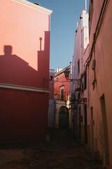 Narrow street in Nardò historic center with colorful walls and evening light