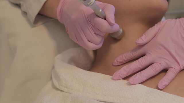 Professional cosmetologist helps to restore the health and youth of facial skin with hardware modern cosmetology. Video 4k close-up.
