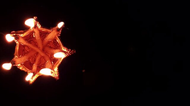 Glowing seven-faced diya burning against a dark background, embodying the essence of Navratri with festive joy, spiritual unity, worship, and the sacred rhythm of Hindu faith.