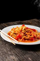 Omelette with tomatoes on a dark background.Asian food. Chinese cuisine