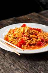 Omelette with tomatoes on a dark background.Asian food. Chinese cuisine