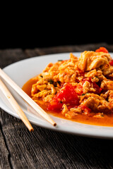 Omelette with tomatoes on a dark background.Asian food. Chinese cuisine