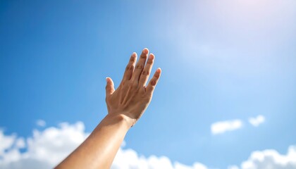Hand reaching towards a bright sky