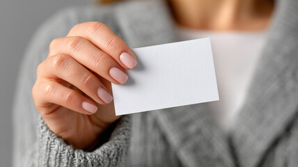 Obraz premium close up of female hand holding small white business card