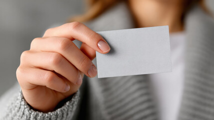 Obraz premium close up of female hand holding small white business card