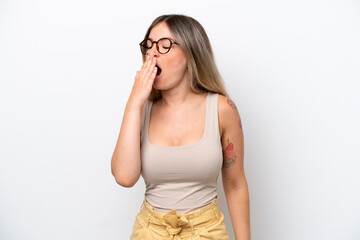 Young Rumanian woman isolated on white background yawning and covering wide open mouth with hand