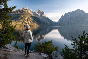traveler stands at foot of majestic mountains equipped with ar technology marking peaks