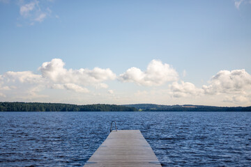 Obraz premium Wooden Pier Extending Into Molkomssjön Lake in Molkom, Sweden on a Summer Day