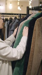 Woman Shopping for Coats in Store
