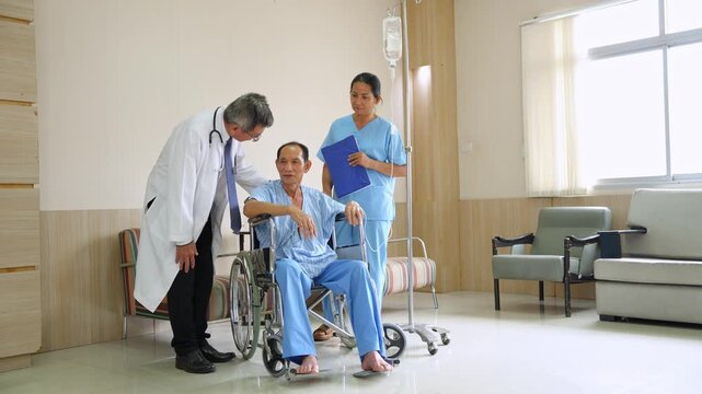 Doctor and nurse take care patient old man with intravenous treatment in wheelchair at hospital	