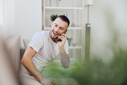 A man enjoying an emotional phone call, reflecting a blend of vulnerability and authentic connection. The image evokes modern feelings of mental health and therapy culture.
