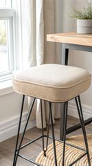 Modern upholstered bar stool with minimalist design in cozy home interior near window and table