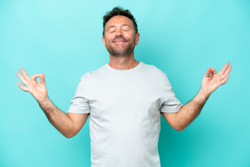 Fototapeta premium Middle age caucasian man isolated on blue background in zen pose