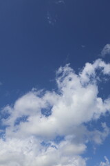 White clouds drifting across vibrant blue sky