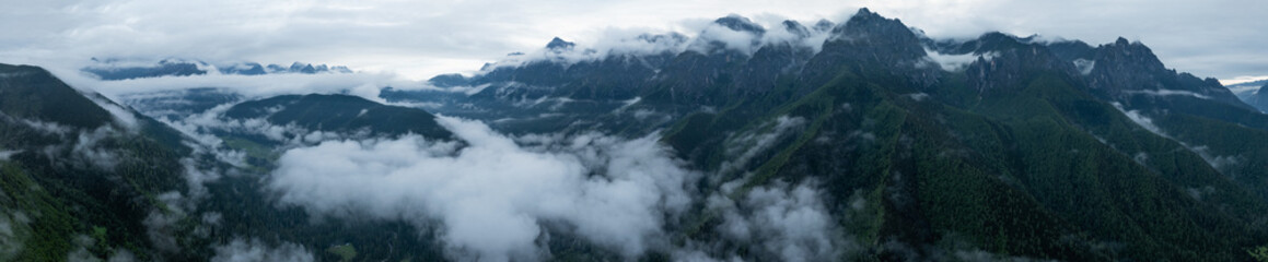 Aerial view of beautiful foggy forest and rocky  mountains landscape