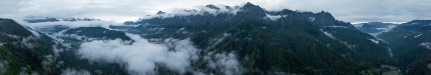Aerial view of beautiful foggy forest and rocky  mountains landscape