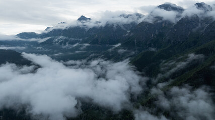 Aerial view of beautiful foggy forest and rocky  mountains landscape