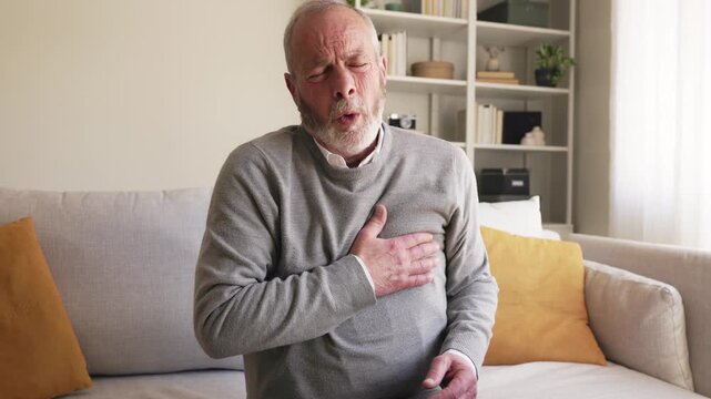 Elderly man suffering heart attack in slow motion
