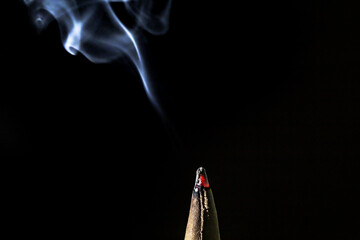burning incense sticks at a Buddhist temple 