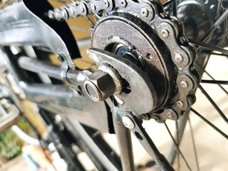 Bicycle rear wheel with chain and gear, closeup of photo