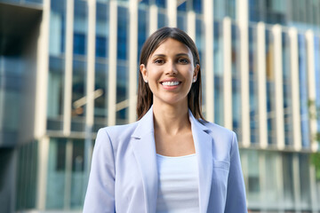 European or latin mature middle age leader female businesswoman at office business building outdoors. Closeup headshot profile portrait of young beautiful hispanic or arabian woman smiling at camera.  © Stock 4 You