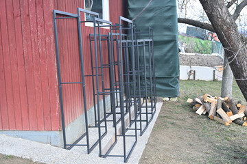 Red wooden house with choped wood for heating in the winter