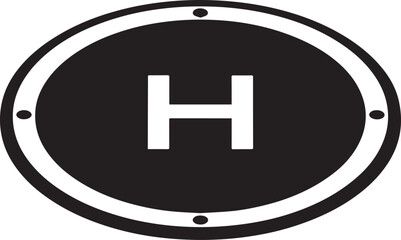  Close-up view of a circular helipad marking featuring a prominent 'H' symbol, indicating a designated helicopter landing area. 