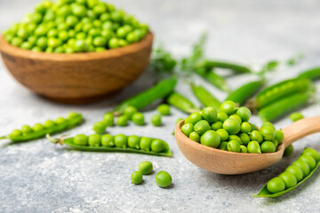 Fresh green pea pods with green peas on a wooden background. Sweet green peas. Green pea beans vegetables. Vegan. healthy vegetable. Copy space