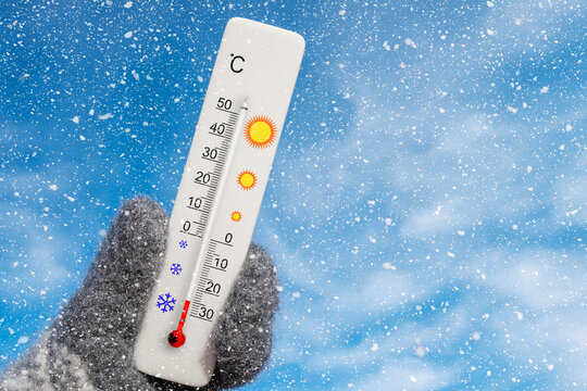 Celsius scale thermometer in hand. Ambient temperature minus 25 degrees celsius
