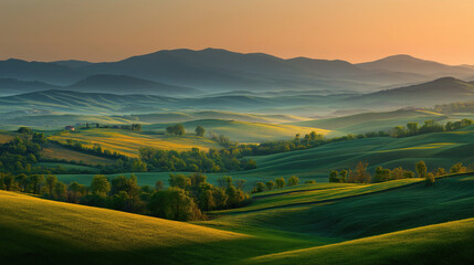 Obraz premium Fresh morning sunrise over green rolling hills in spring, panoramic dreamy shot
