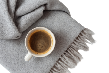 A cup of coffee on a gray blanket