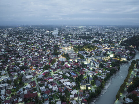Aerial view of the Rioni River snaking through the cityscape, the Bagrati Cathedral gleaming amidst the urban sprawl, Kutaisi, Imereti, Georgia.