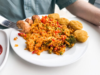 Plate with rice, nuggets and vegetables. Fast food, casual lunch and everyday dining concept.
