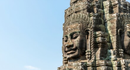 Ancient stone face carving at bayon temple in cambodia