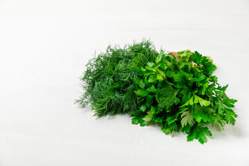 Dill and parsley on the texture table. Mixed bunch of fresh parsley and dill. Fresh aromatic spicy greens. Spices and herbs. Space for text. Copy space