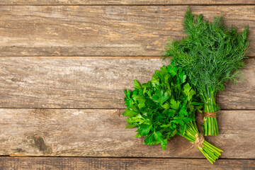 Dill and parsley on the texture table. Mixed bunch of fresh parsley and dill. Fresh aromatic spicy greens. Spices and herbs. Space for text. Copy space