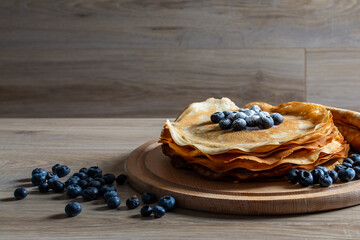 Sweet morning delight: thin crepes with blueberries and sugar powder