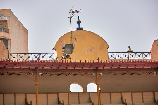 A rooftop with old antennas and a camera on a dome structure, possibly part of a bullring. Practical lesson at Corrida School. tradition, architecture