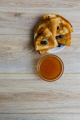 Sweet morning delight: thin crepes with blueberries and sugar powder