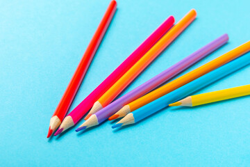 Colored pencils on a bright colored background. Equipment for coloring. Stationery for creativity.Back to school. Flatlay. Children's Creativity and Education. Rainbow.Space for text. Copy space.