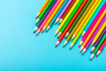 Colored pencils on a bright colored background. Equipment for coloring. Stationery for creativity.Back to school. Flatlay. Children's Creativity and Education. Rainbow.Space for text. Copy space.