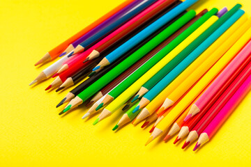 Colored pencils on a bright colored background. Equipment for coloring. Stationery for creativity.Back to school. Flatlay. Children's Creativity and Education. Rainbow.Space for text. Copy space.
