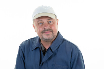 portrait of caucasian handsome middle-aged man with cap and beard wearing a blue worker jacket fashion hipster against a white isolated background